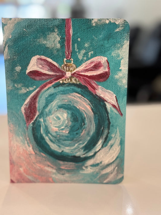 teal Christmas ornament with pink bow