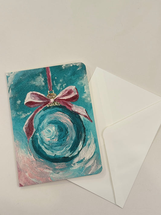 teal Christmas ornament with pink bow